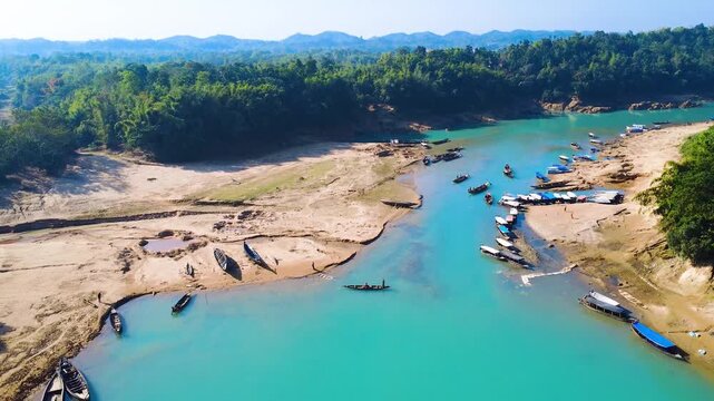 A scenic drone view of the Lalakhal Sari-Goain River in Jaintapur, Sylhet, from above the clear blue sky, which is known as a famous tourist destination in Bangladesh for its clear blue waters.