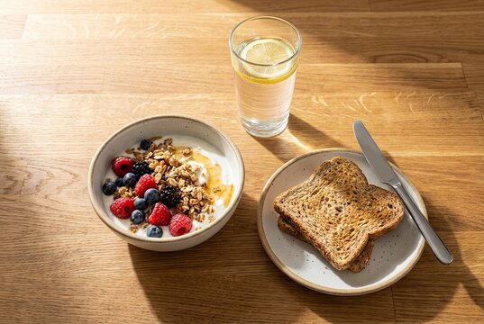Healthy Skyr Breakfast with Whole Grain Toast and Water on Sunny Kitchen Island