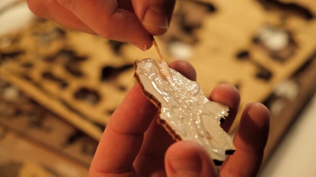A man smears a wooden part with PVA glue in close-up. The creative process of creating DIY crafts. Gluing a world map from individual pieces of countries. Hobby concept. Carpentry. High quality 4K.