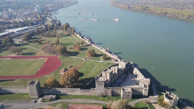 Pull away drone shot of the medieval Smederevo fortification and Danube river in Serbia. 