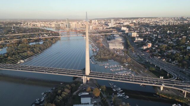 Golden hour aerial panorama of Ada Bridge and Belgrade skyline
