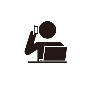 パソコン操作しながらスマホで電話をする人のピクトグラムアイコン