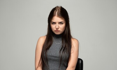 Fototapeta premium Young woman showing frustration, feeling disappointment, looking upset and annoyed with a sad frown