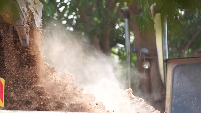 Earth Mover on the Move: Capturing the intense motion of earth being transported, a bulldozer actively shifts the ground, showcasing the raw power and essential work of land management and groundwork.