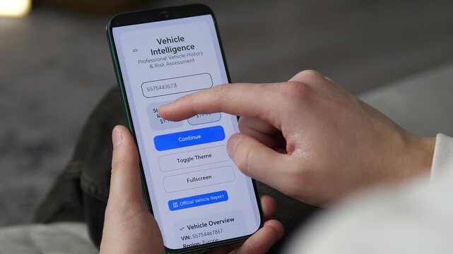 Close-up of user typing VIN number into a vehicle history app on smartphone. Person checking car background and risk assessment before buying a used car. Automotive data concept.