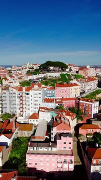 Establishing shot of Lisbon rooftops with hilltop viewpoint in Graca. Miradouro da Senhora do Monte in Lisbon, Portugal. vertical video