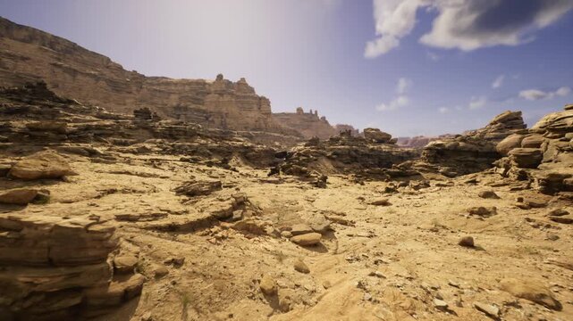 rugged rocky foreground under brooding sky with patchy clouds and dramatic light, rough sandstone textures, strewn stones and gullies suggest recent weathering,