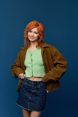 Embracing spring fashion with youthful style against a vibrant blue backdrop