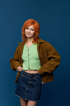 Embracing spring fashion with youthful style against a vibrant blue backdrop