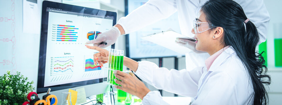 Scientists team discussing and analyzing sustainability data in a modern laboratory, making data-driven decisions for green energy solutions, climate action, and net zero innovation strategies.