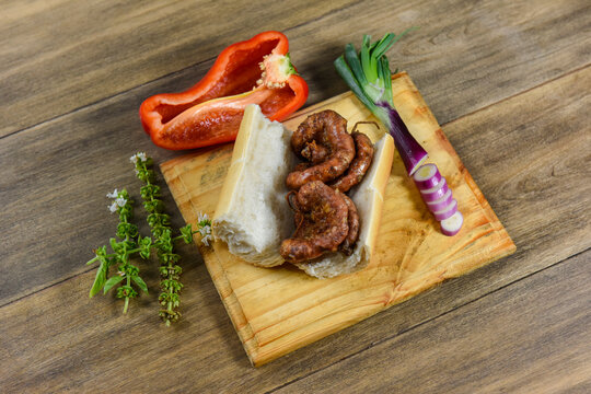 Cow bowels presented on a wooden board with ingredients, ready to grill