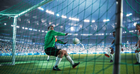Obraz premium Professional Male Soccer Goalkeeper Reacts Inside the Goal as a Close-range Shot Flies in During an International Championship Match, Capturing Decisive World Football Action in a Packed Stadium.