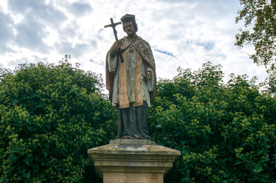 Statue of Saint John of Nepomuk in Mokre (sołectwo), crucifix in his hand, 1900, figure is polychromed. Mikoł&oacute;w, Poland.