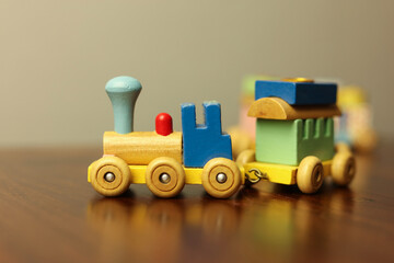 Colorful Vintage Wooden Toy Train on Warm Wooden Surface