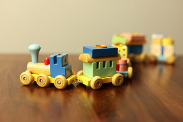 Colorful Vintage Wooden Toy Train on Warm Wooden Surface
