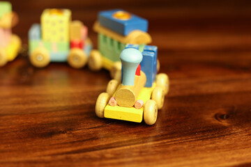 Colorful Vintage Wooden Toy Train on Warm Wooden Surface