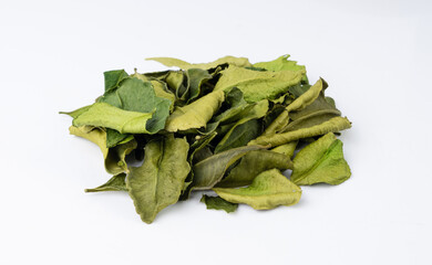 Fototapeta premium Thai lime dried leaves isolated, makrut lime or Citrus hystrix leaf pile, kaffir lime dry sprouts, Asia spices