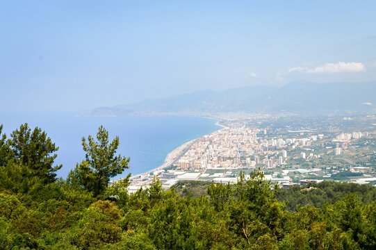 Panoramic view of Mahmutlar, Alanya coastline with Mediterranean Sea, beach and cityscape from mountain viewpoint on summer day