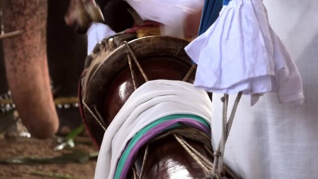 A Thimila (a traditional percussion drum) artist's performance in the procession of a temple festival in Kerala, India