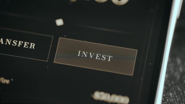 Person taps the digital button INVEST