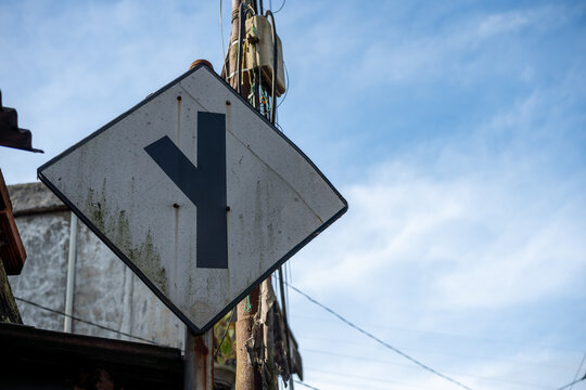 Weathered Y Intersection Traffic Sign Against a Cloudy Sky