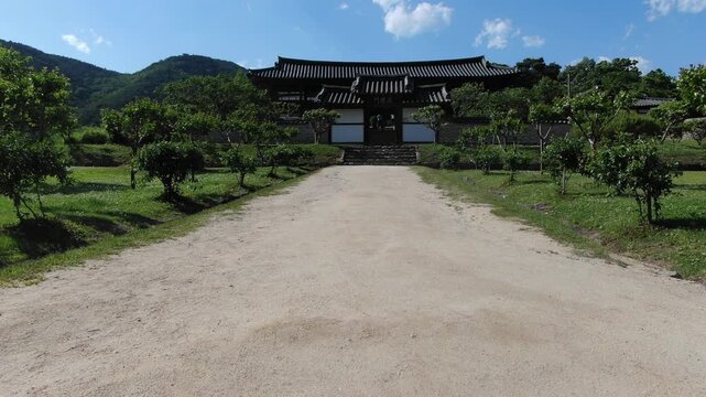 Aerial rising shot of Byeongsan Seowon showing traditional Hanok and surrounding mountains, Andong, South Korea
