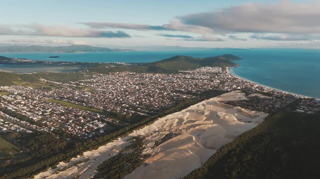 Aerial view of the town of Ingleses and its dunes during sunrise on the island of Santa Catarina. Florianopolis, Brazil