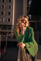 Fototapeta premium Businesswoman smiling during phone call at golden hour