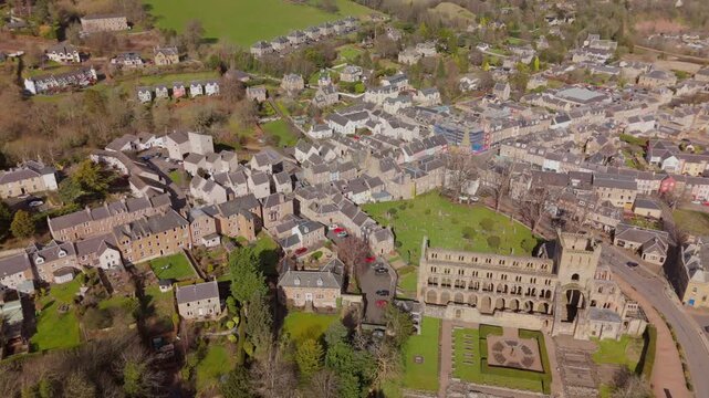 Drone view of Jedburgh, Scottish Borders buildings and hills on a sunny day