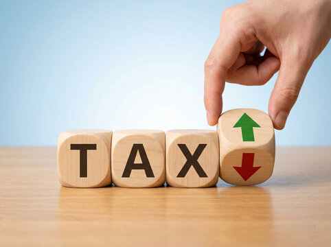 finance tax concept with wooden cubes and arrow block showing increase decrease business planning visual
