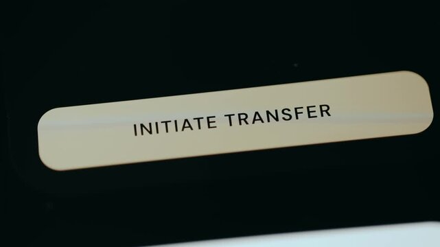 Person taps the button labeled Initiate Transfer from a banking application