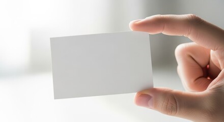 Obraz premium Hand holding blank business card mockup for presentation and design