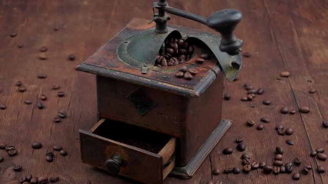 Grinding coffee with an old-woden fashioned grinder