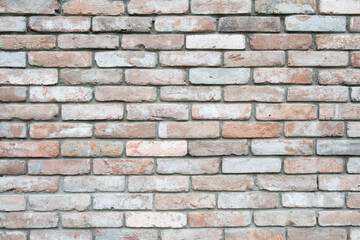 Fototapeta premium Antique brick wall surface, architectural detail for interior or exterior design. Multi-colored old brick wall texture background, rustic style.