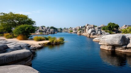 Fototapeta premium The landscape shows a body of water surrounded by large rock formations and an island. Hills can be seen under a blue sky