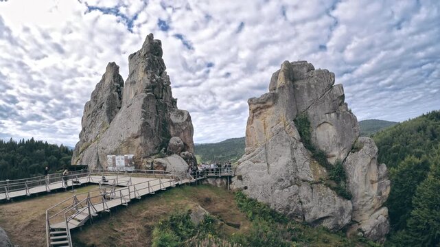 Tustan, Lviv Region, Ukraine - August 2025: Tourists walking among rock formations at Tustan fortress complex