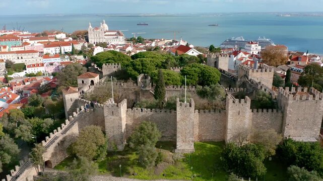 Aerial drone footage showing sao jorge castle and tagus river in historic old town alfama lisbon portugal