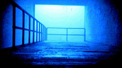 Fototapeta premium Mysterious Blue Tunnel with Bright Light at the End