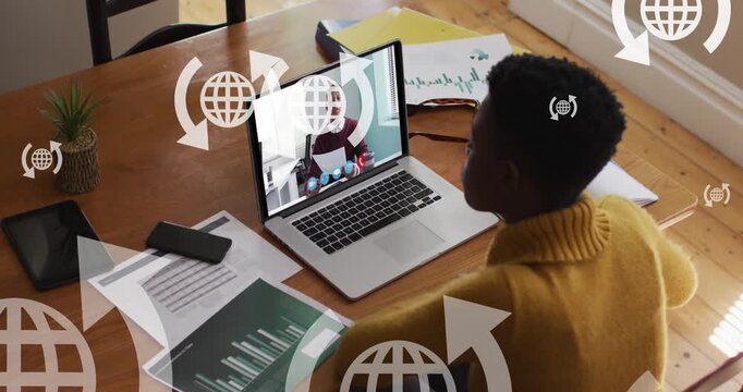 Animation of multiple web globe icons over african american woman having a video call on laptop