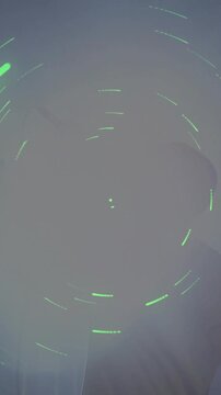 Vertical video: Singer gripping mic and singing at concert, LEDs swelling into shadow then fading