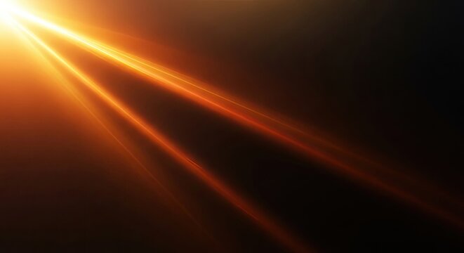 Vibrant orange sunbeam shining through darkness with radiant light rays