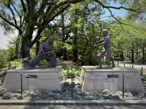 Samurai statues in a park in Kitakyushu, Japan surrounded by greenery