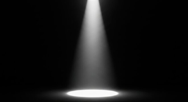 A single spotlight shining brightly in a dark room with a narrow beam of light