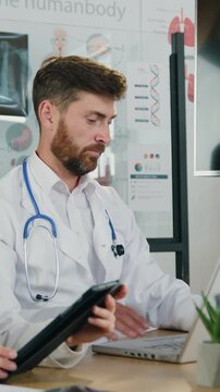 Medical concept where attractive concentrated high-skilled man and woman both medical specialists listening their workmate which explaining chest x-ray and lungs scan during consultation in clinic