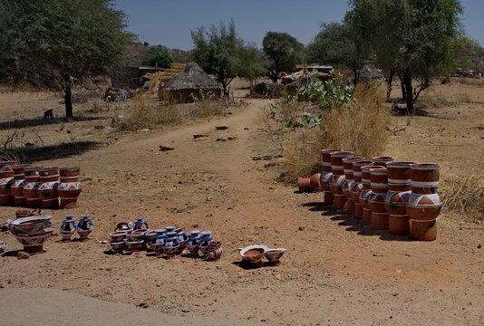 Central Africa, Chad, Mongo.  a view of painted clay vessels of various sizes and shapes offered for sale on the side of the road.