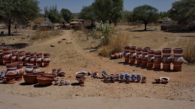 Central Africa, Chad, Mongo.  a view of painted clay vessels of various sizes and shapes offered for sale on the side of the road.