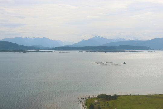 View from plane on mountains, fjord and fish farm, Norway