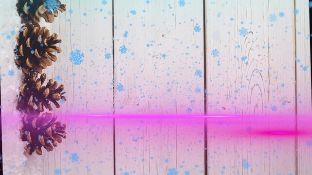 Animation of light trails and snowflakes over cones at christmas