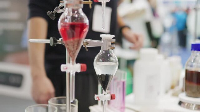 Separating funnels filtering liquids in science laboratory