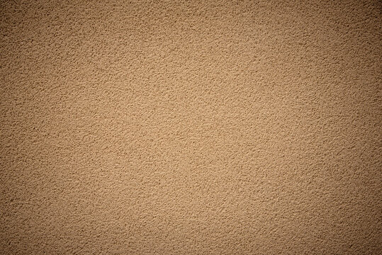 Close up of a brown sandstone texture wall with a rough grainy surface. concept of abstract background, architectural material, construction detail, natural stone finish and interior decoration.